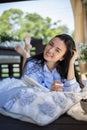 Focused brunette woman thinking imagination with notepad at nature summer outdoor village terrace