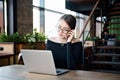 Focused business woman sit on cafe working on laptop, concentrated serious female working with computer and notebook in coffee sho Royalty Free Stock Photo