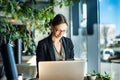 Focused business woman in stylish glasses sit on cafe working on laptop, concentrated serious female working with computer Royalty Free Stock Photo