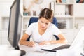 Focused business woman working with laptop and documents Royalty Free Stock Photo
