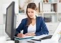 Focused business woman working with laptop and documents Royalty Free Stock Photo