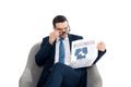 focused businessman adjusting eyeglasses and reading newspaper while sitting in armchair Royalty Free Stock Photo