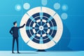 Focused Businessman Aiming High at Big Dart Board for Success on Blue Background. Royalty Free Stock Photo
