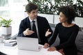 Focused businessman communicating with motivated african american female colleague. Royalty Free Stock Photo