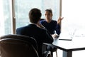 Focused businessman discussing working issues with female partner. Royalty Free Stock Photo