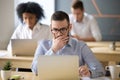 Focused businessman solving online problem working on laptop in Royalty Free Stock Photo