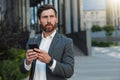 Focused Businessman in suit going home after long working day and using phone Royalty Free Stock Photo