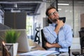 Focused businessman thinking at modern office into report file calculating stock market earnings, startup business Royalty Free Stock Photo