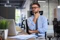 Focused businessman thinking at modern office into report file calculating stock market earnings, startup business Royalty Free Stock Photo