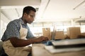 Focused businessman typing an email. Young fashion designer working on his laptop. Creative entrepreneur working in his Royalty Free Stock Photo