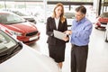 Focused businessman undersign a car contract