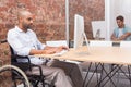 Focused businessman in wheelchair working at his desk