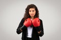 Determined businesswoman with red boxing gloves Royalty Free Stock Photo