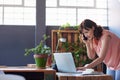 Focused businesswoman talking on her cellphone and using a laptop Royalty Free Stock Photo