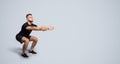 Focused calm handsome strong millennial european guy with beard in sportswear squat