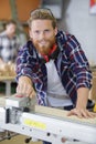 focused carpenter at work with wooden plank Royalty Free Stock Photo