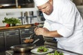 Focused chef prepares steak dish at gourmet restaurant