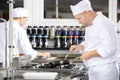 Focused chefs makes food in professional kitchen Royalty Free Stock Photo