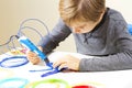 Focused child with 3d printing pen creating a plane Royalty Free Stock Photo