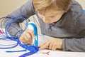 Focused child with 3d printing pen creating a plane