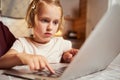 Focused child pressing one button on laptop keyboard Royalty Free Stock Photo