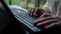 Close-up of Hands Typing on a Computer Keyboard with Digital Financial Charts Blurred in the Background for Business and Royalty Free Stock Photo