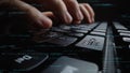 Close-Up of Hands Typing on Laptop Keyboard Surrounded by Lines of Code Representing Programming and Data Processing in Royalty Free Stock Photo