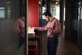 Serious young office worker making photocopy on photocopier