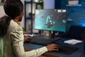 Focused concentrated woman gamer sitting at desk in gaming home studio