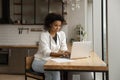 Focused confident African American businesswoman using laptop, working online