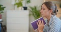 Contemplative Woman Reading Book on Living Room Sofa