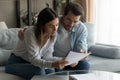 Focused couple read news in post paper letter