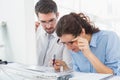 Focused coworkers looking photos together Royalty Free Stock Photo