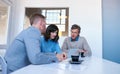 Focused coworkers using a digital tablet together in an office