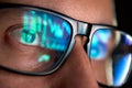 Trader looking at computer screen analyzing trading chart reflecting in glasses. Royalty Free Stock Photo