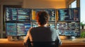 Programmer working at a multi-monitor setup with code and data analysis screens Royalty Free Stock Photo