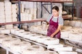 Female ceramicist filling casting molds with slip in pottery workshop Royalty Free Stock Photo