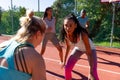 Focused diverse female friends playing basketball at basketball court