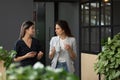 Millennial multiethnic female colleagues chat enjoying coffee break