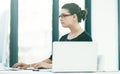 Focused on doing more. a young businesswoman working at her desk in an office.