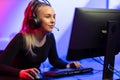 Focused E-sport Gamer Girl with Headset Playing Online Video Game on PC Royalty Free Stock Photo