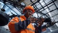 Focused engineer tapping glass tablet at huge manufacturing factory closeup