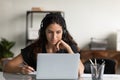 Focused female adult student in headphones using laptop Royalty Free Stock Photo