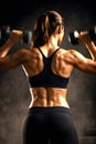 Focused Female Athlete Executing Controlled Dumbbell Shoulder Press Exercise In Studio Royalty Free Stock Photo