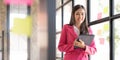 Focused female business woman planning ideas on a glass wall with colorful sticky notes inside a modern and creative Royalty Free Stock Photo