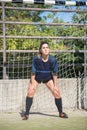 Focused female goalkeeper standing in goals