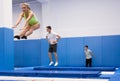 Female gymnast exercising L shape on trampoline