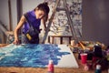 Focused female painter artist creating a new piece