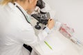 Focused female science student looking in a microscope in a laboratory Royalty Free Stock Photo