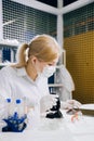 focused female science student looking in a microscope in a laboratory Royalty Free Stock Photo